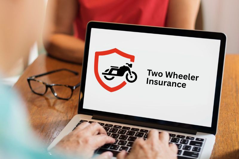 a person is searching of two wheeler insurance on laptop